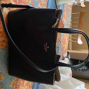 Small Kate Spade purse with crossbody strap.